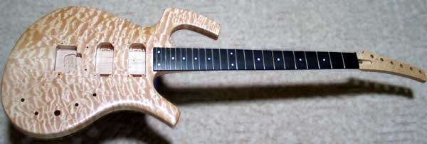 Electric guitar using a commercially produced neck mounted on curly maple. Click the image for an enlarged view.